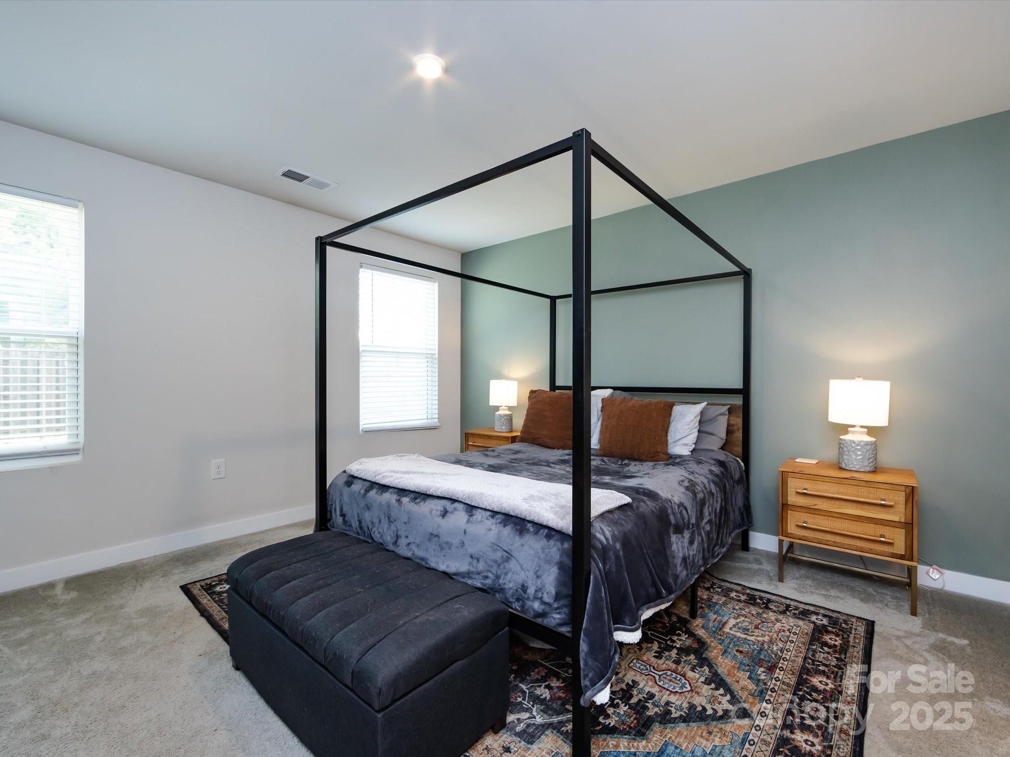 4231 Mackinnon Drive Charlotte, NC 28214 - Photo 22 of 35 a bedroom with a bed and wooden floor