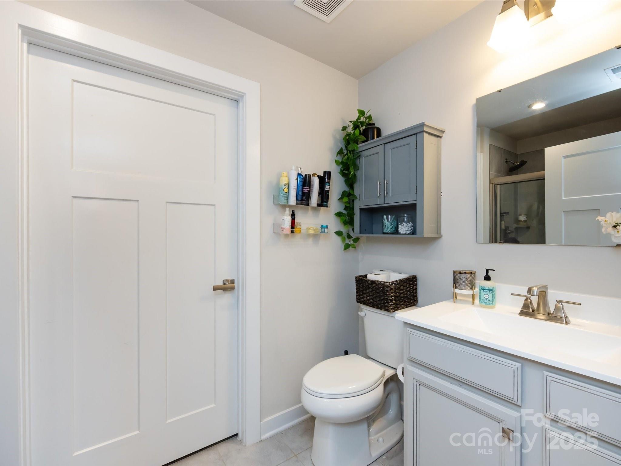 4231 Mackinnon Drive Charlotte, NC 28214 - Photo 24 of 35 a bathroom with a sink toilet and mirror