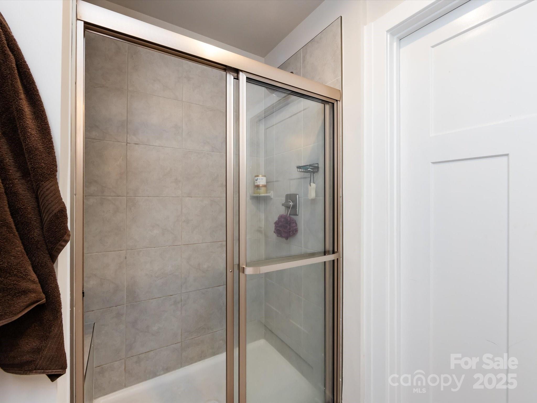 4231 Mackinnon Drive Charlotte, NC 28214 - Photo 25 of 35 a bathroom with a glass shower door
