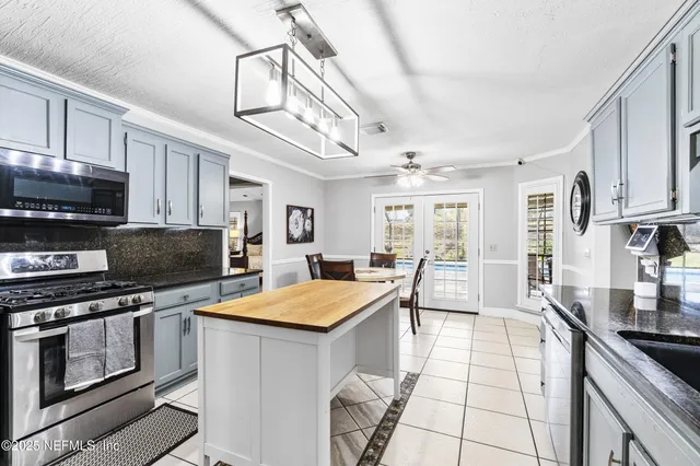 a bedroom with a bed and a flat tv screen on wall