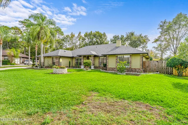 a front view of house with yard and green space