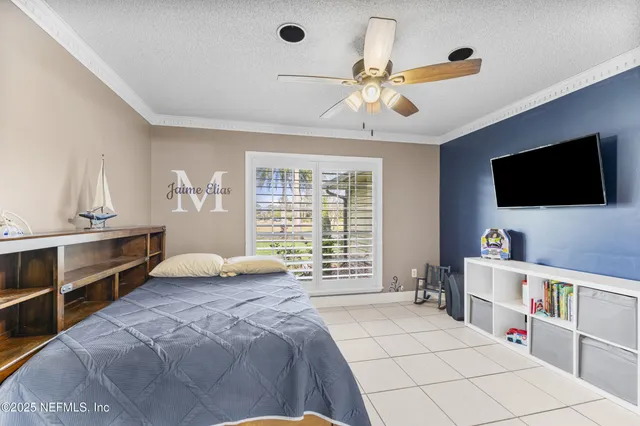 a bedroom with a large bed and a flat screen tv