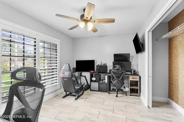 a bathroom with a granite countertop sink mirror vanity and toilet