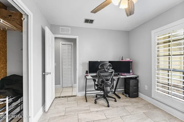 a bedroom with a bed and a tv