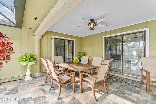 a view of a house with garden and a sitting area