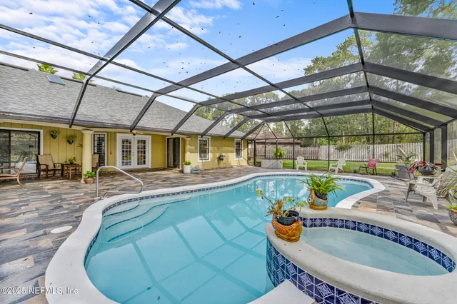 a view of a backyard with swimming pool