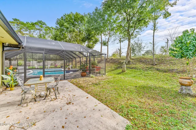 an aerial view of a houses with a yard