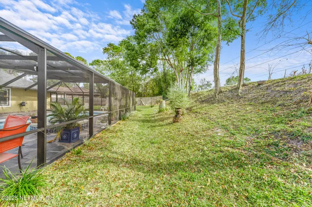 a view of a patio with a table and chairs under an umbrella
