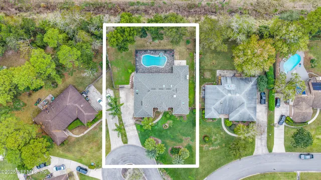 a view of a patio with table and chairs under an umbrella