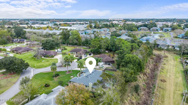 an aerial view of a house with outdoor space and a lake view
