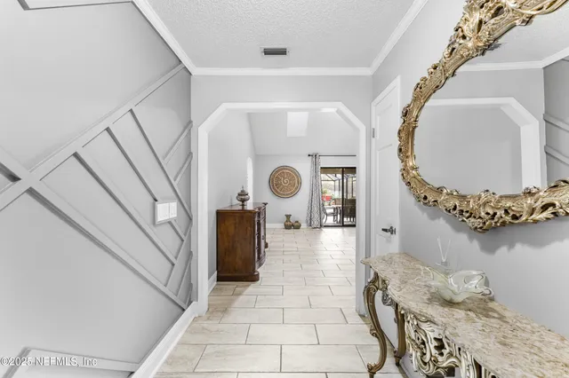 a view of a bedroom with a chandelier and wooden floor