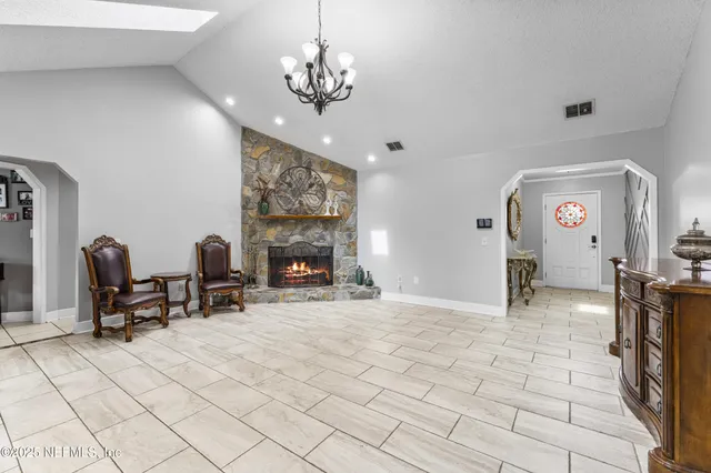 a living room with furniture a flat screen tv and a table