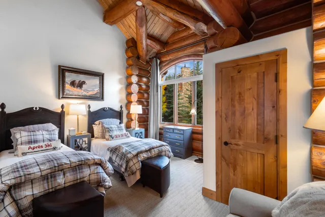 a bedroom with two beds and a window