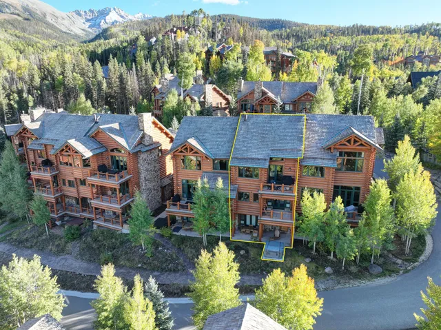 an aerial view of multiple houses with yard