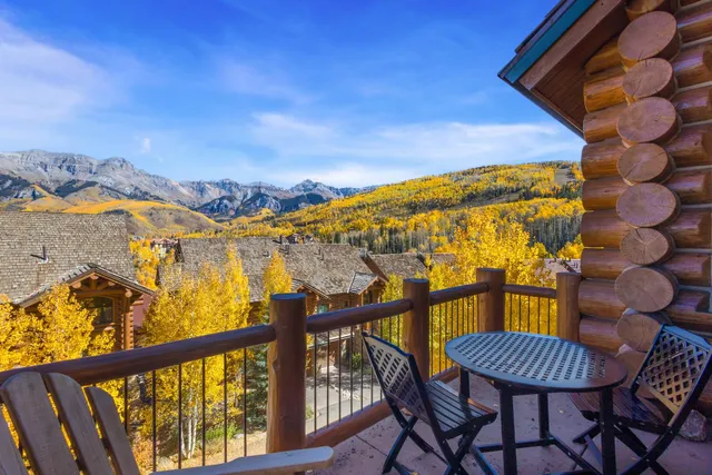 a view of a chairs and table in the balcony