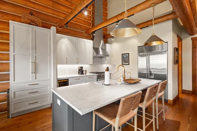 a kitchen with stainless steel appliances granite countertop a sink a stove and refrigerator