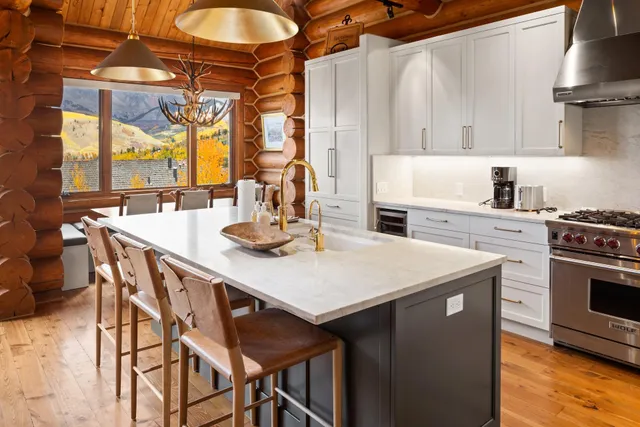 a kitchen with a stove a sink and a refrigerator