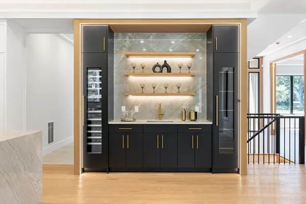a view of a hallway with wooden floor and cabinet