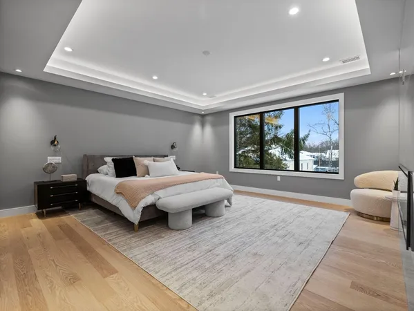 a bedroom with a large bed and a large window