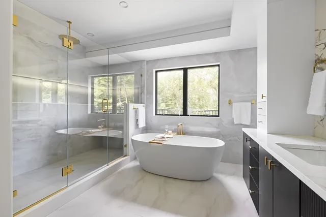 a spacious bathroom with a bathtub and a sink