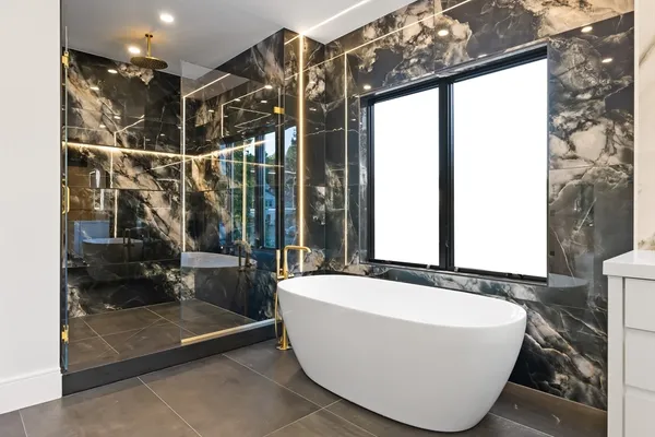 a bathroom with a bathtub and next to a window