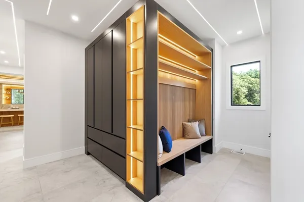 a view of a hallway with bathroom and wooden floor