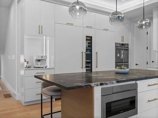 a kitchen with stainless steel appliances granite countertop a sink a stove and cabinets