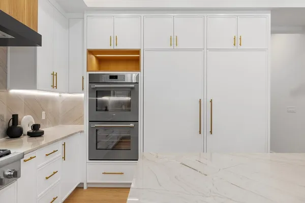 a kitchen with cabinets and a refrigerator