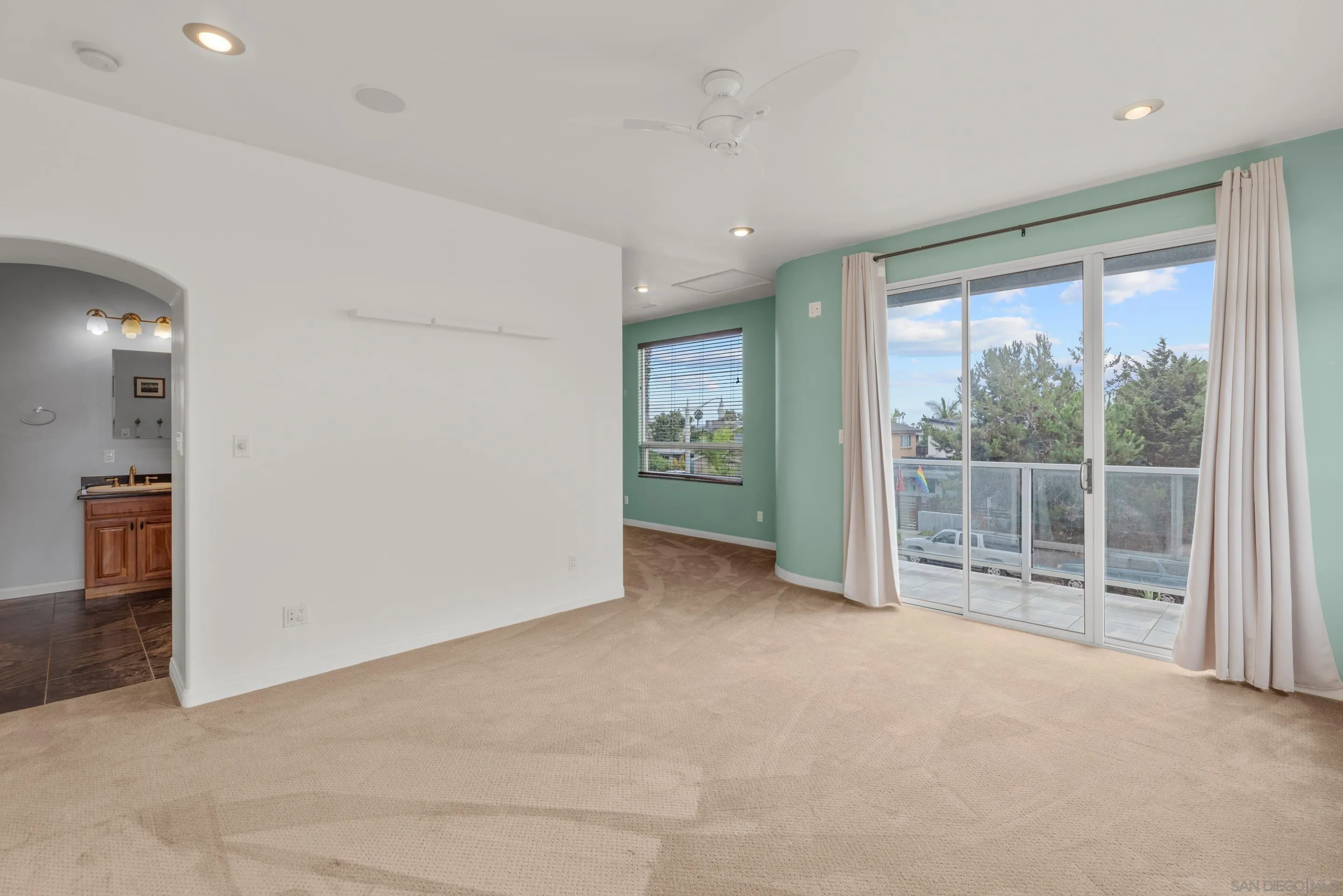 4975 Dawes Street San Diego, CA 92109 - Photo 17 of 39 an empty room with sliding glass door and mountain view