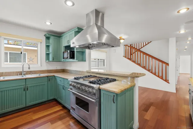a kitchen with stainless steel appliances granite countertop a stove and a sink