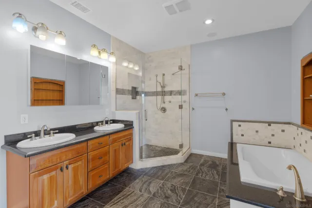 a bathroom with a tub sink and mirror