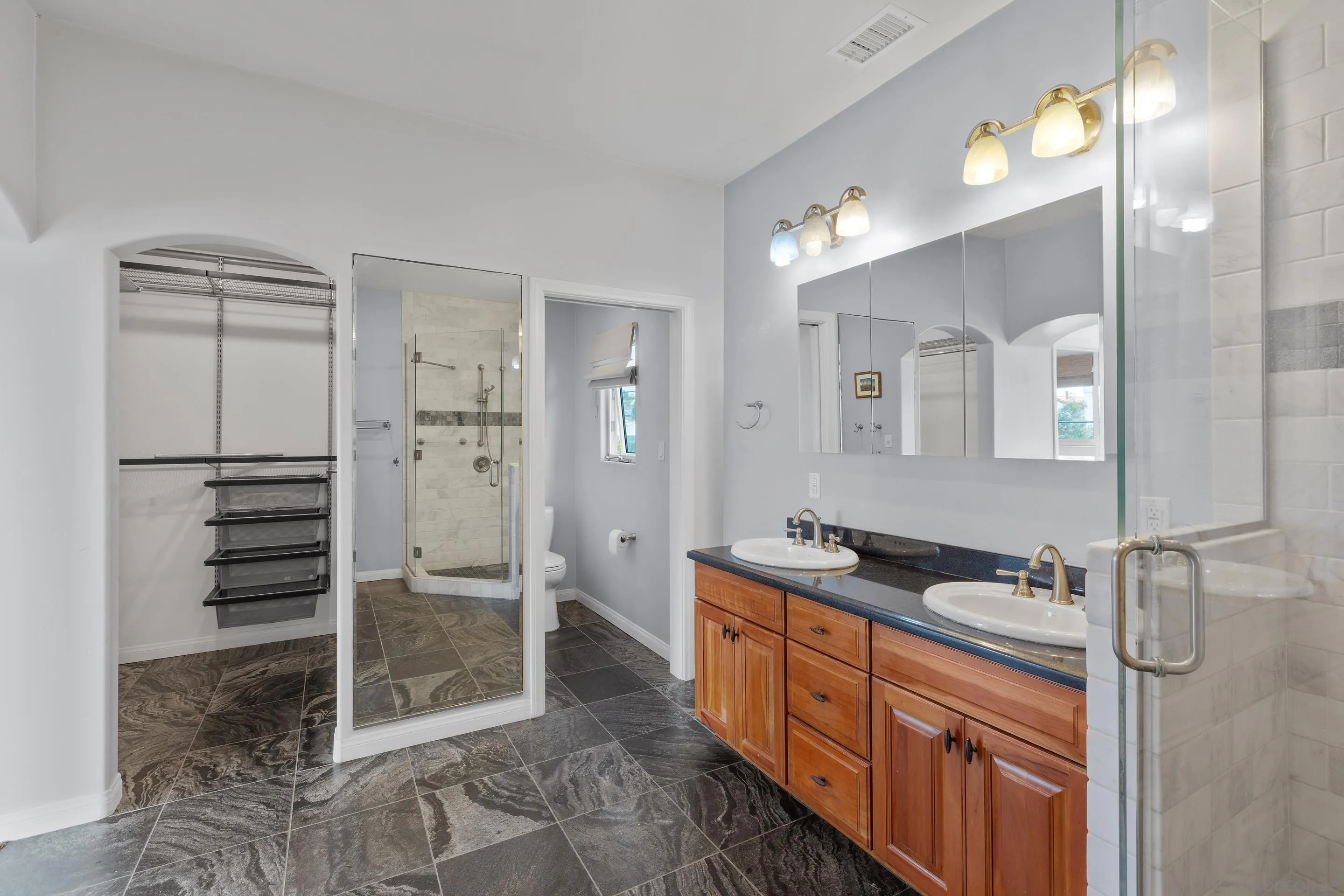 4975 Dawes Street San Diego, CA 92109 - Photo 24 of 39 a spacious bathroom with a double vanity sink a mirror and shower