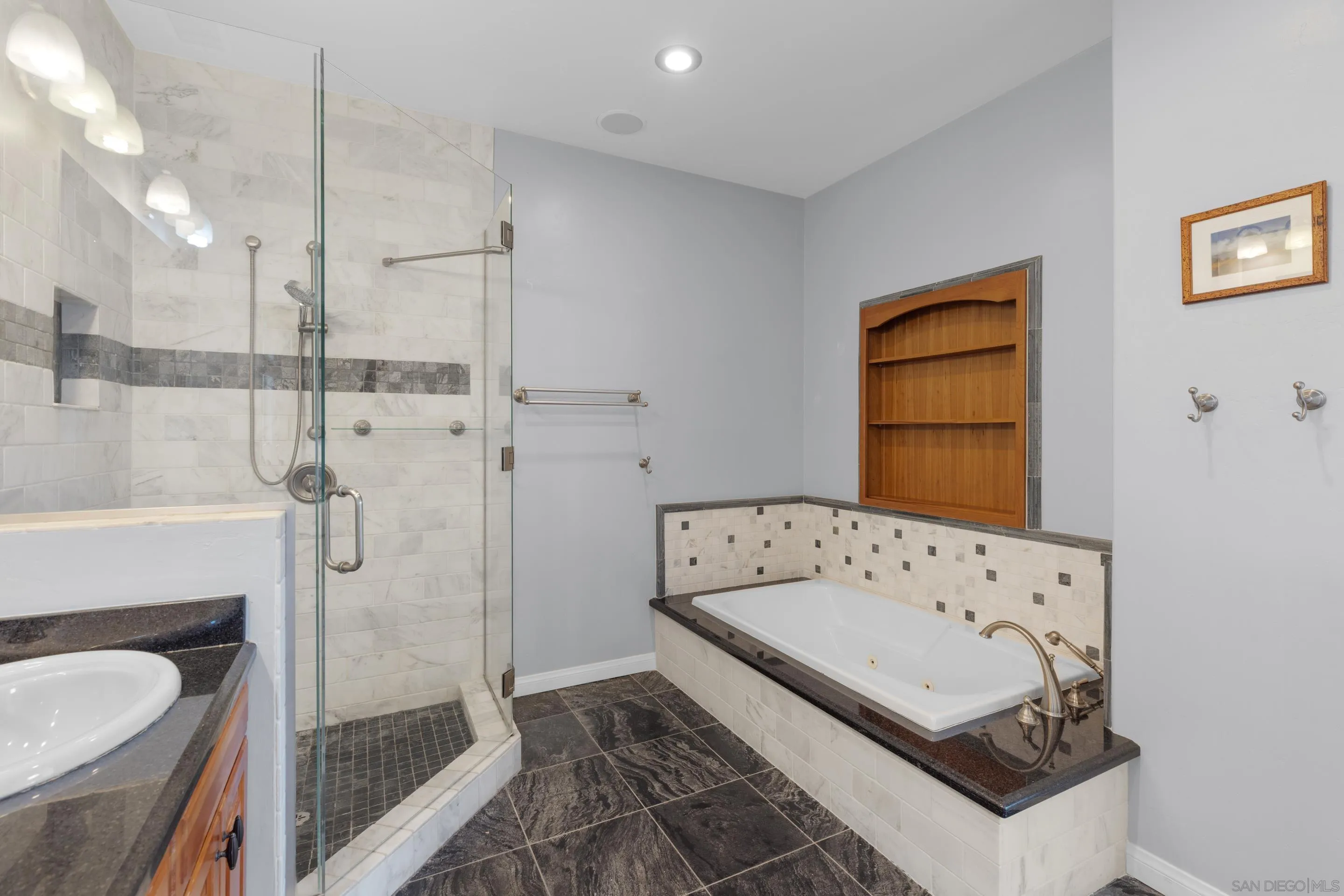 4975 Dawes Street San Diego, CA 92109 - Photo 25 of 39 a bathroom with a tub sink and mirror