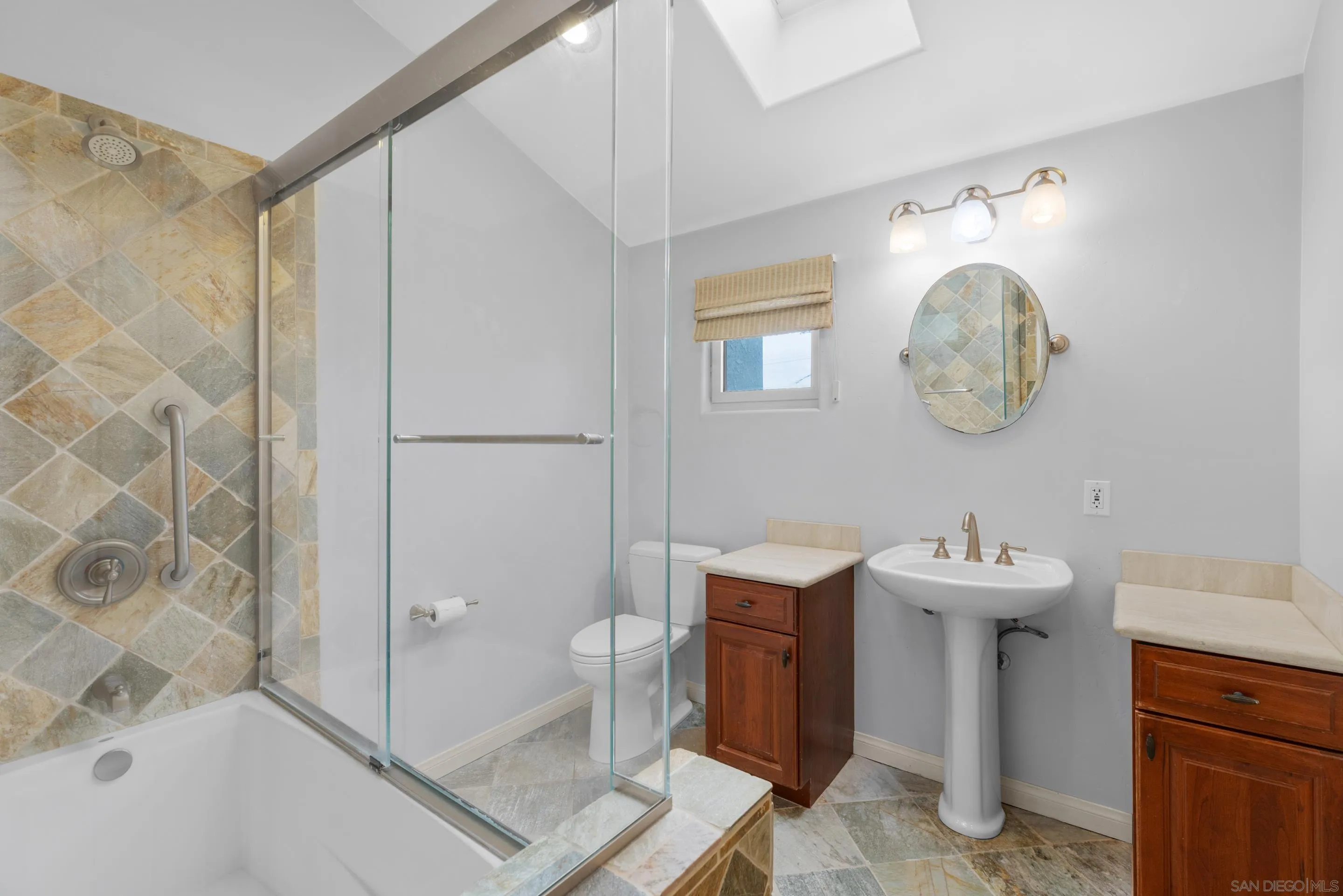 4975 Dawes Street San Diego, CA 92109 - Photo 32 of 39 a bathroom with a sink a toilet and shower