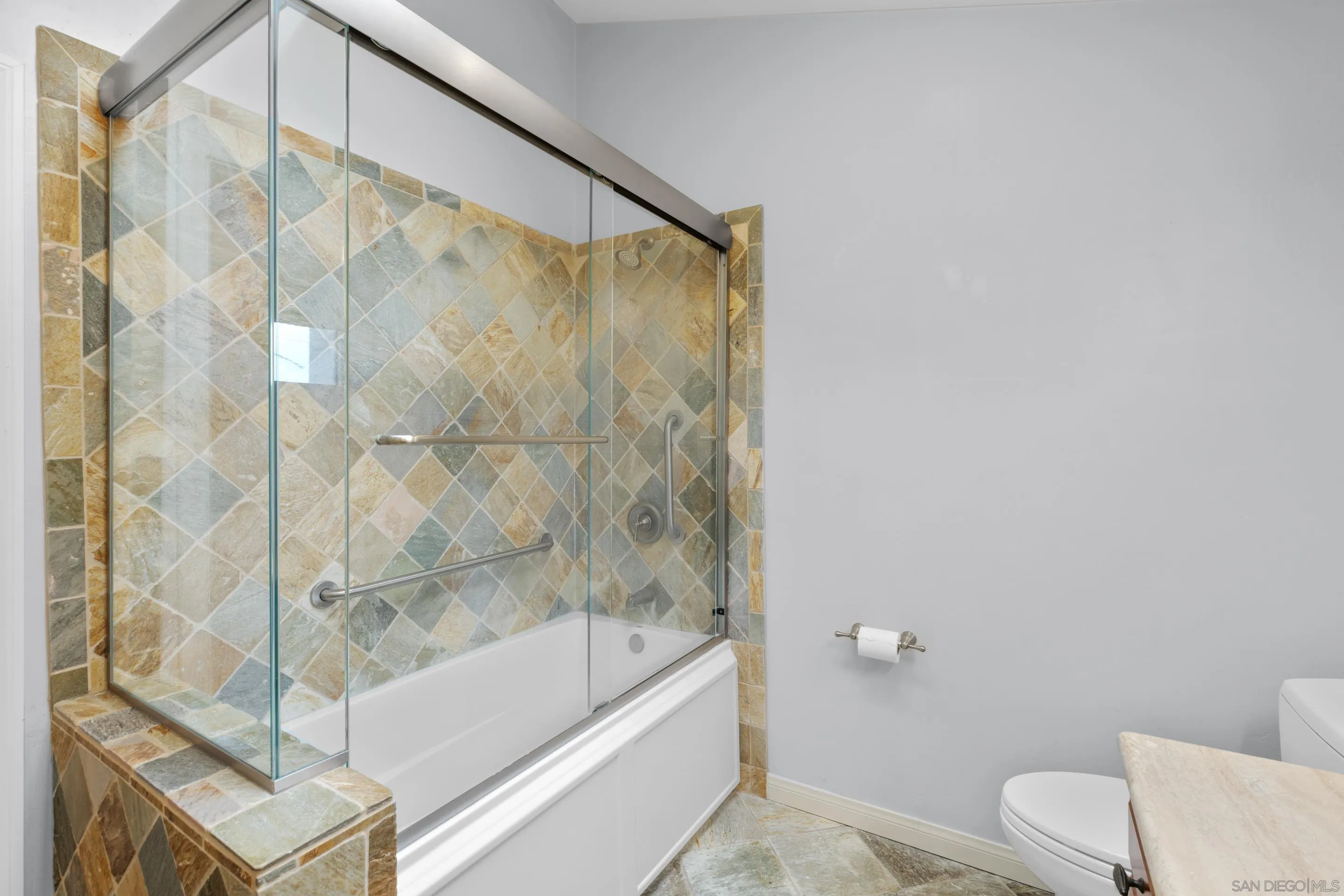 4975 Dawes Street San Diego, CA 92109 - Photo 33 of 39 a bathroom with a bathtub and a shower