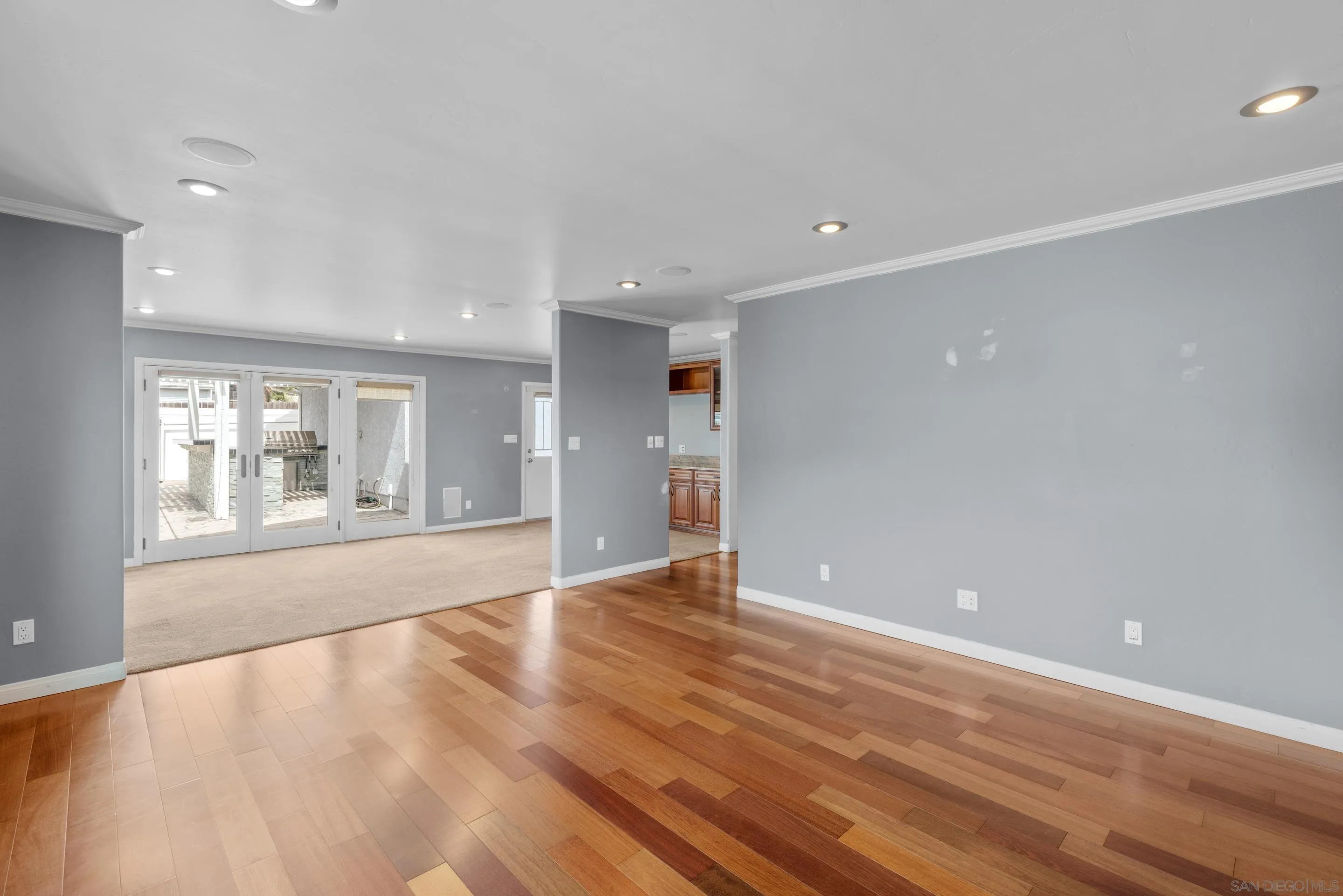4975 Dawes Street San Diego, CA 92109 - Photo 4 of 39 a view of an empty room with wooden floor and a window