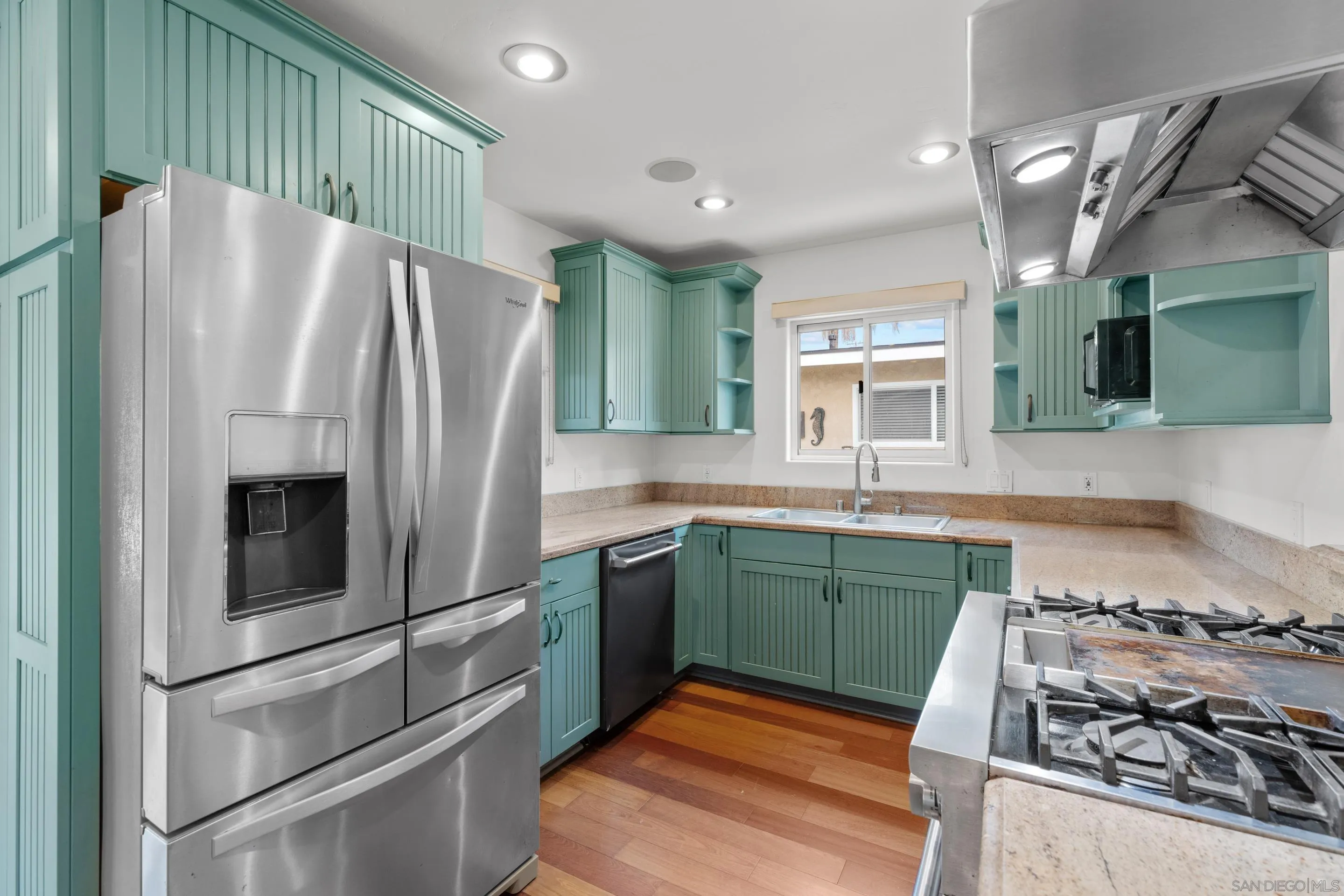 4975 Dawes Street San Diego, CA 92109 - Photo 5 of 39 a kitchen with granite countertop a refrigerator and a sink