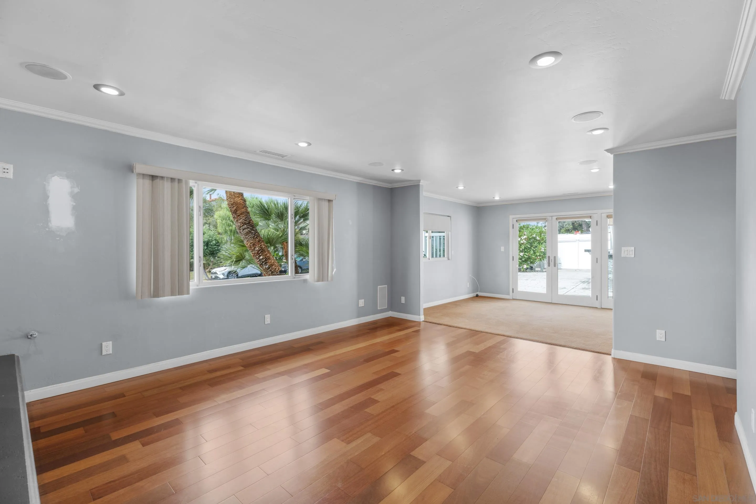 4975 Dawes Street San Diego, CA 92109 - Photo 8 of 39 an empty room with wooden floor and windows