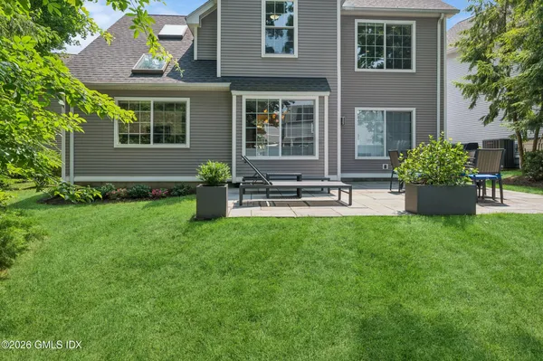 a front view of house with yard and outdoor seating