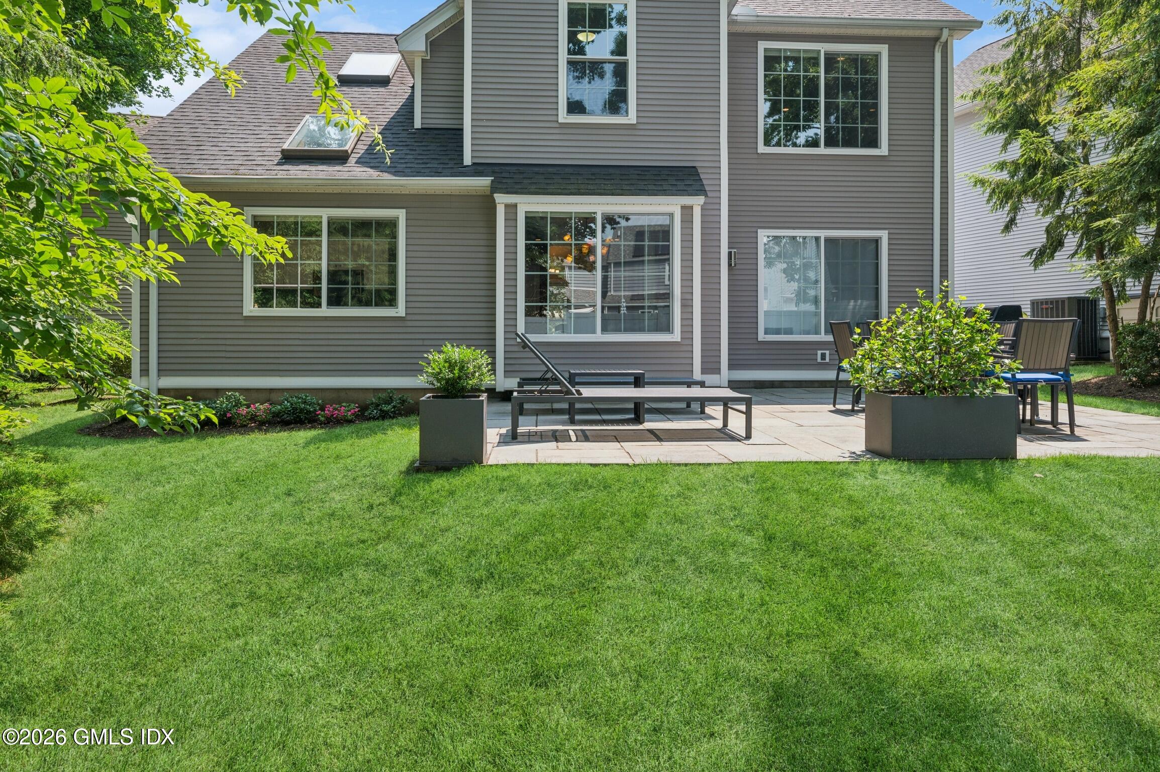 115 Top Gallant Road, Unit 6 Stamford, CT 06902 - Photo 16 of 18 a front view of house with yard and outdoor seating