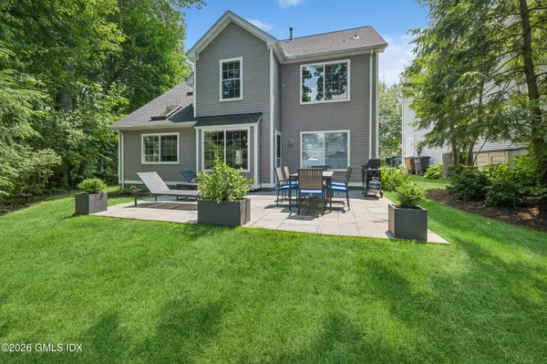 a front view of a house with patio and garden
