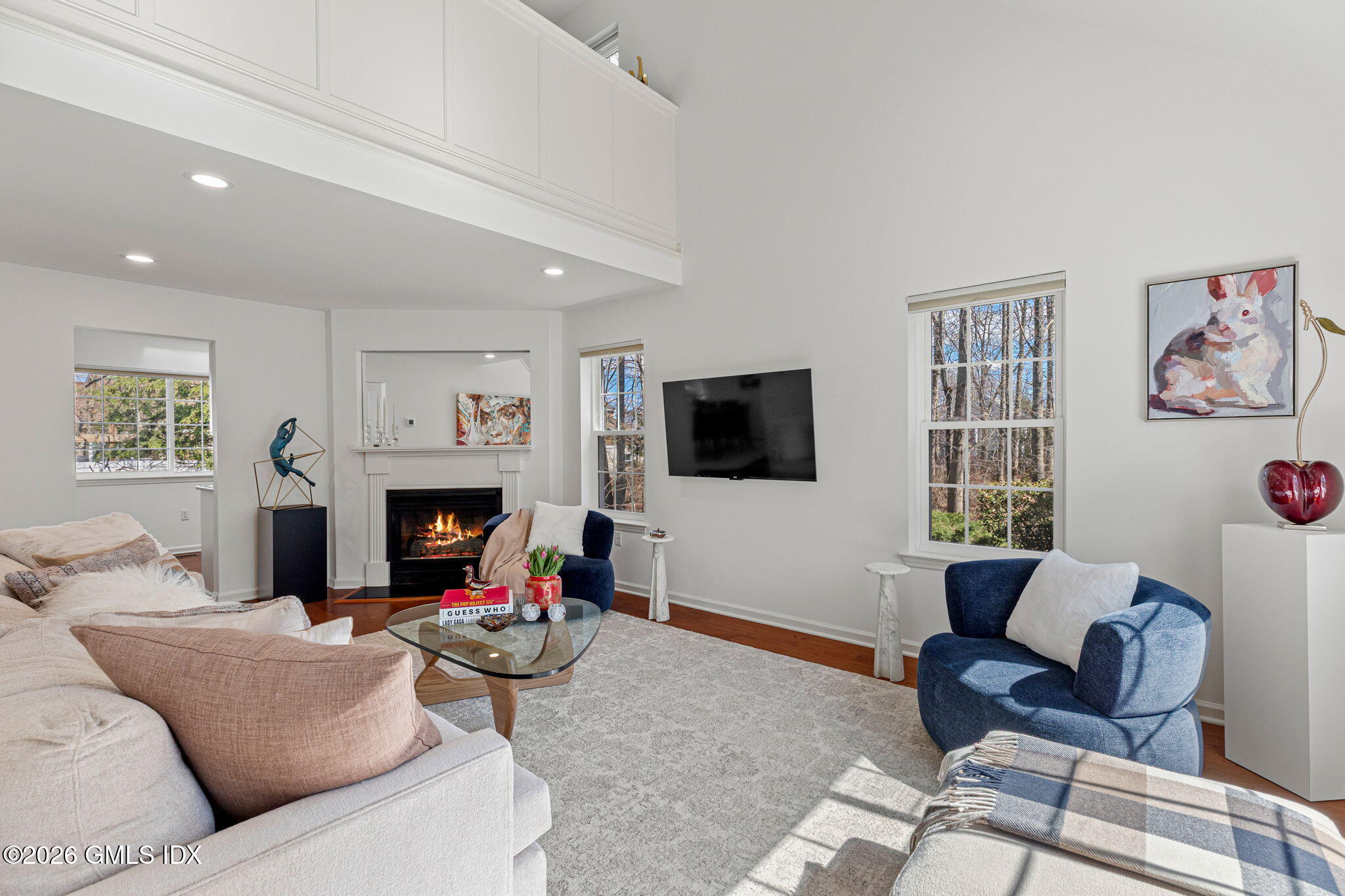 115 Top Gallant Road, Unit 6 Stamford, CT 06902 - Photo 2 of 18 a living room with furniture a flat screen tv and a fireplace