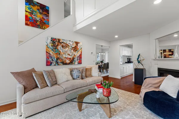 a living room with furniture and kitchen view