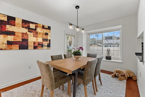 a view of a dining room with furniture window and wooden floor