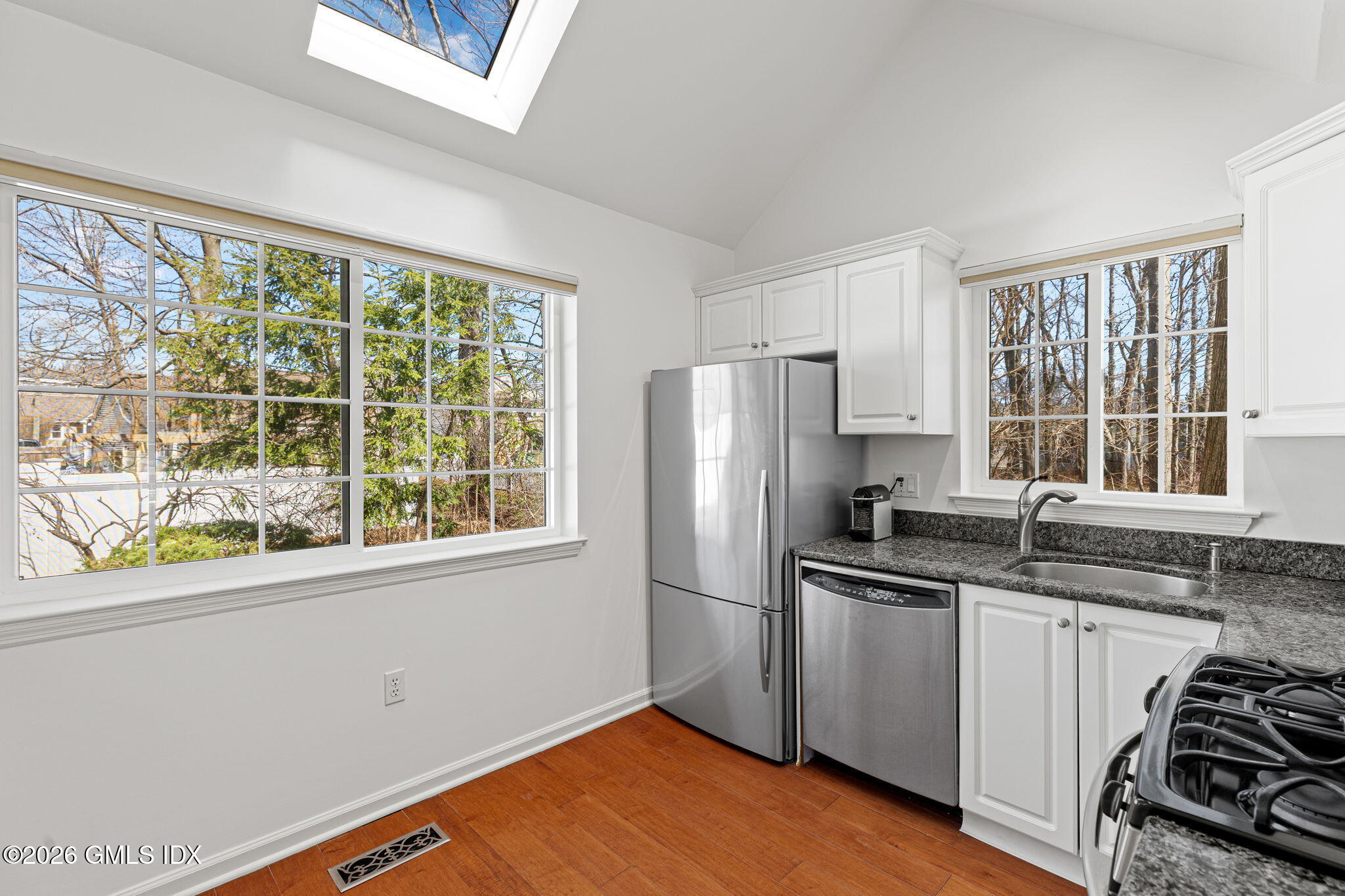 115 Top Gallant Road, Unit 6 Stamford, CT 06902 - Photo 8 of 18 a kitchen with stainless steel appliances granite countertop a sink stove and refrigerator