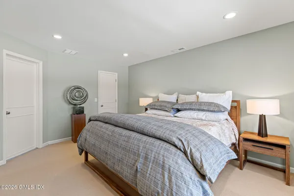 a bedroom with a bed and a lamp on table