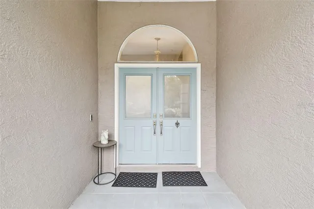 a view of a dining room with furniture a chandelier and wooden floor