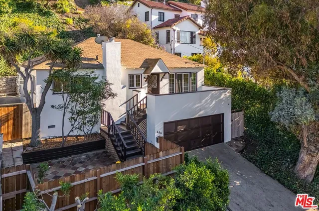 an aerial view of a house with a yard