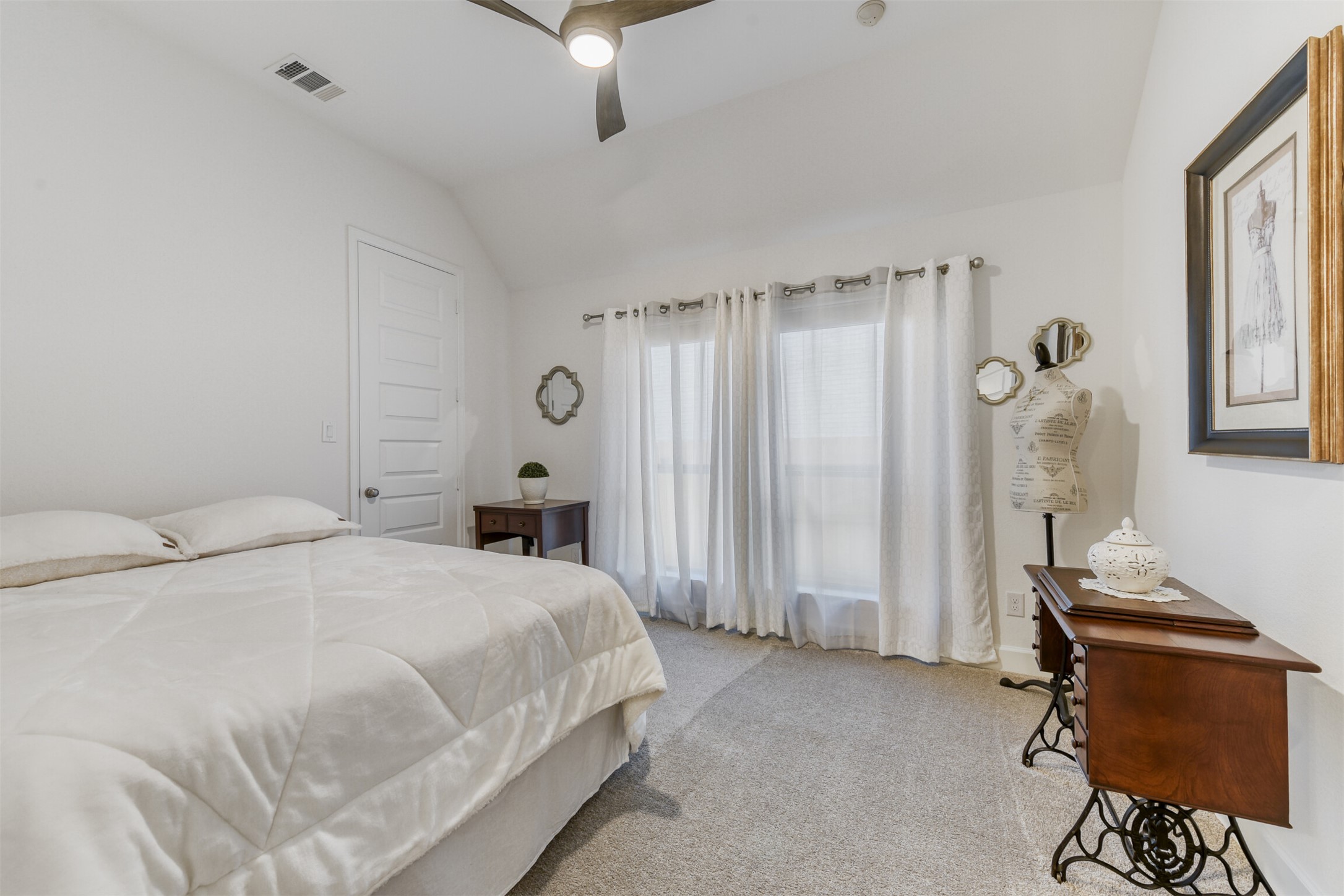 345 Prickly Poppy Loop Kyle, TX 78640 - Photo 20 of 28 Bedroom with vaulted ceiling, carpet flooring, and a ceiling fan