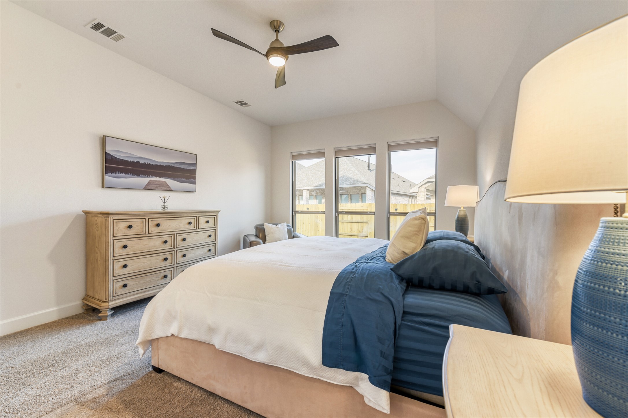 345 Prickly Poppy Loop Kyle, TX 78640 - Photo 22 of 28 Bedroom featuring a ceiling fan, carpet, and vaulted ceiling